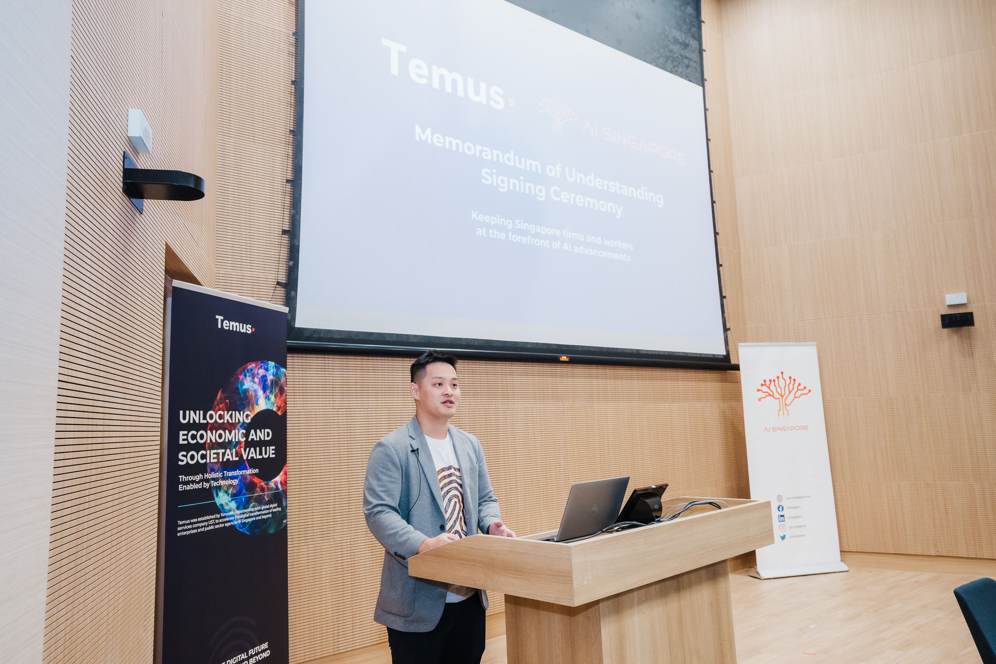 John Ang speaking at a Temus and AI Singapore event